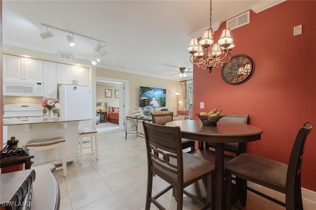 dining room with ceiling fan with notable chandelier, light tile patterned floors, rail lighting, and ornamental molding