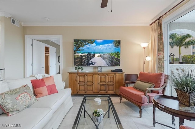 living room featuring ceiling fan, crown molding, and light tile patterned flooring