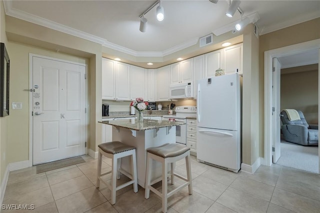 kitchen with a breakfast bar, white appliances, white cabinets, crown molding, and light stone counters