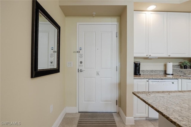 entryway with light tile patterned flooring