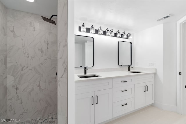 bathroom featuring vanity and tiled shower