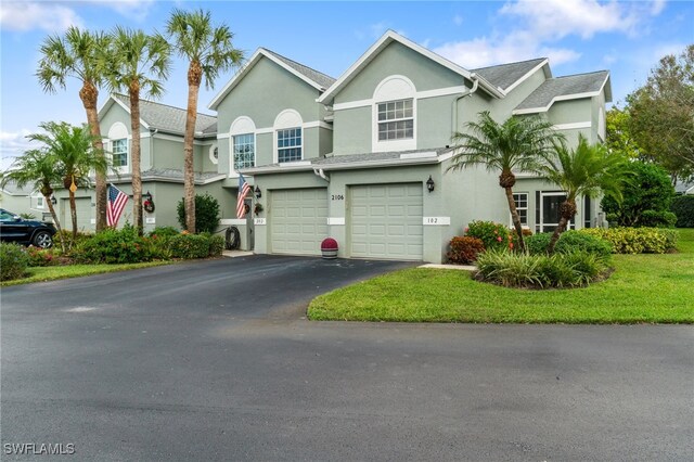 view of front facade featuring a front lawn and a garage