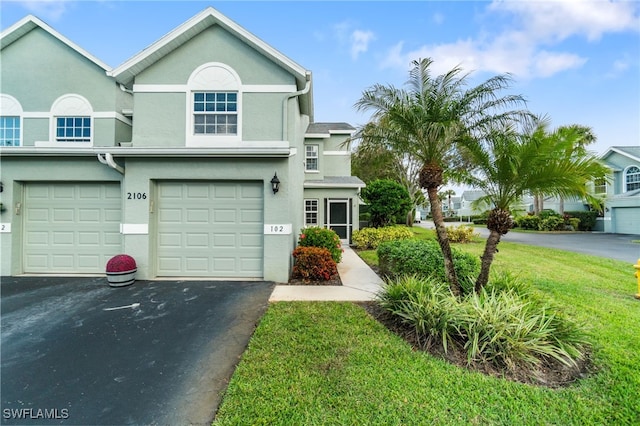 view of front of home with a garage and a front yard