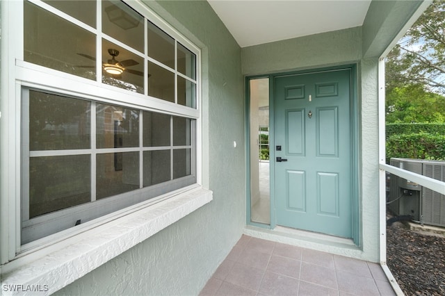 view of exterior entry with central AC unit