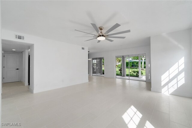 tiled empty room featuring ceiling fan