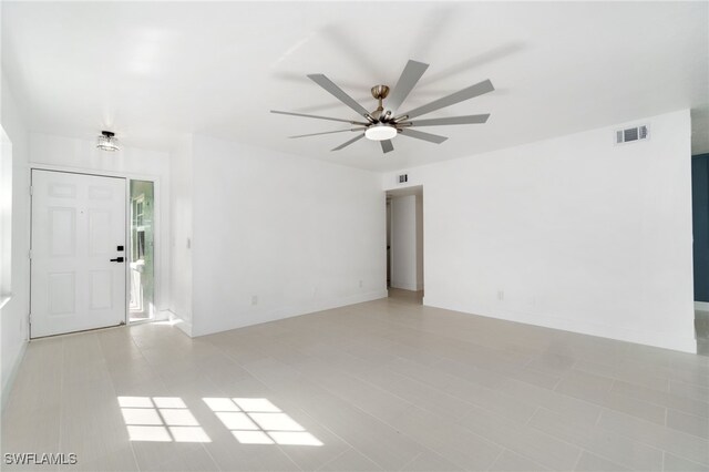 unfurnished room with ceiling fan and light tile patterned flooring