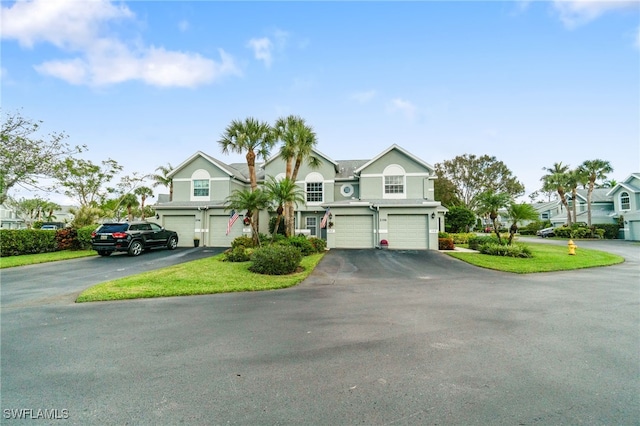 view of front of property featuring a front yard and a garage