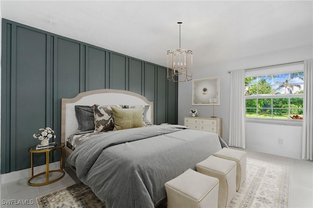 tiled bedroom with a notable chandelier and a decorative wall