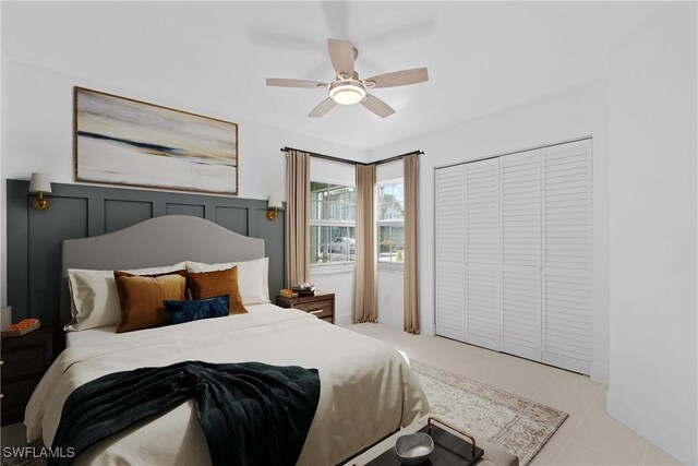 tiled bedroom with ceiling fan and a closet