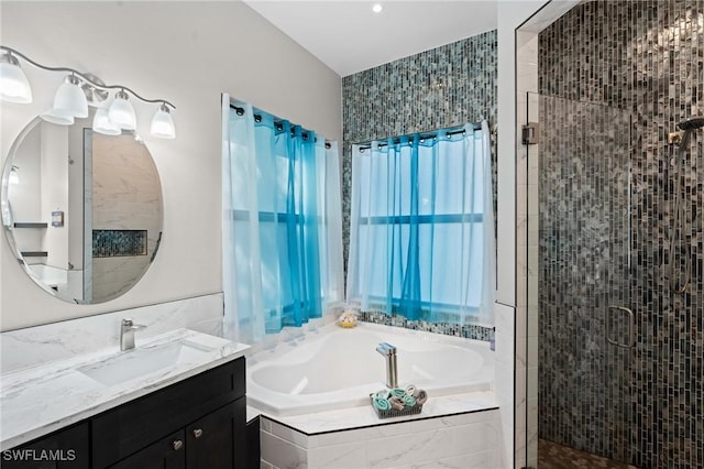 full bath with vanity, a stall shower, a garden tub, and tile walls