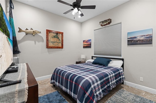 bedroom featuring a ceiling fan and baseboards