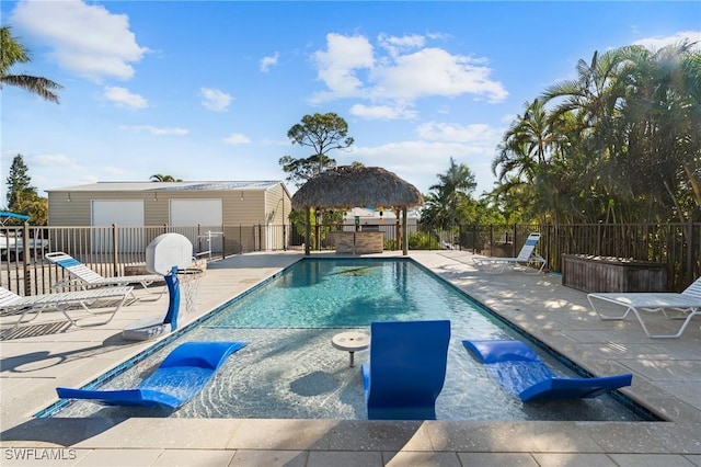 view of swimming pool featuring a patio area, fence, a fenced in pool, and a gazebo