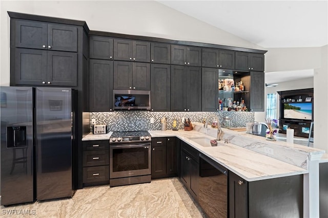 kitchen featuring open shelves, stainless steel appliances, tasteful backsplash, vaulted ceiling, and a sink