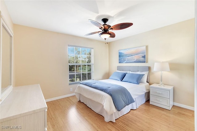 bedroom with ceiling fan and light hardwood / wood-style floors