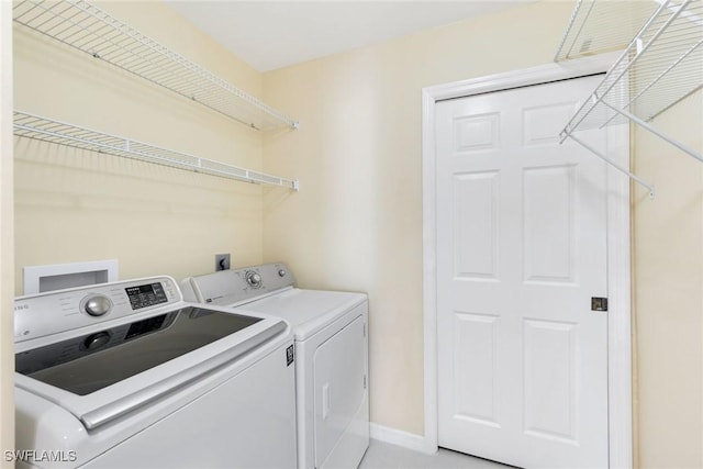 washroom with washing machine and clothes dryer