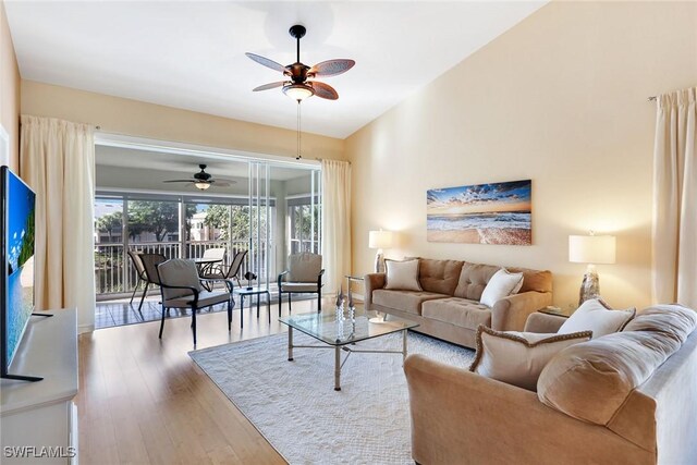 living room featuring hardwood / wood-style flooring and ceiling fan