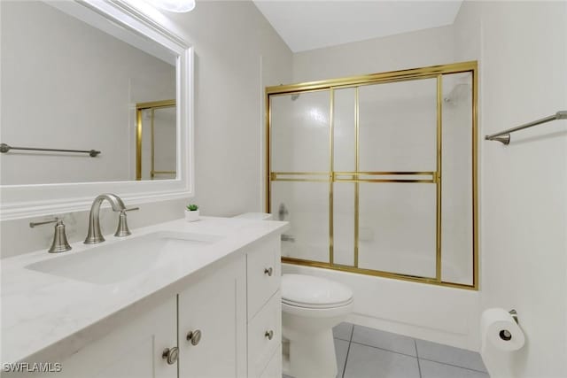 full bathroom featuring tile patterned flooring, enclosed tub / shower combo, vanity, and toilet