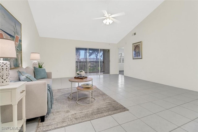 living room with ceiling fan, light tile patterned floors, and high vaulted ceiling