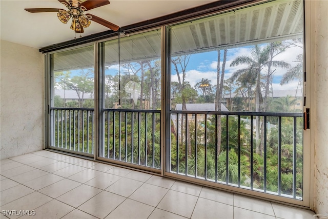 unfurnished sunroom with ceiling fan and plenty of natural light