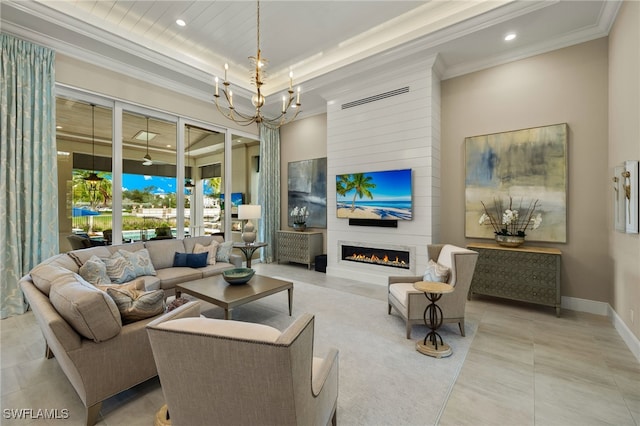 living room featuring a fireplace, a chandelier, and crown molding