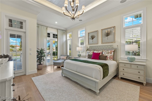 bedroom featuring access to outside, french doors, ornamental molding, a notable chandelier, and light hardwood / wood-style floors