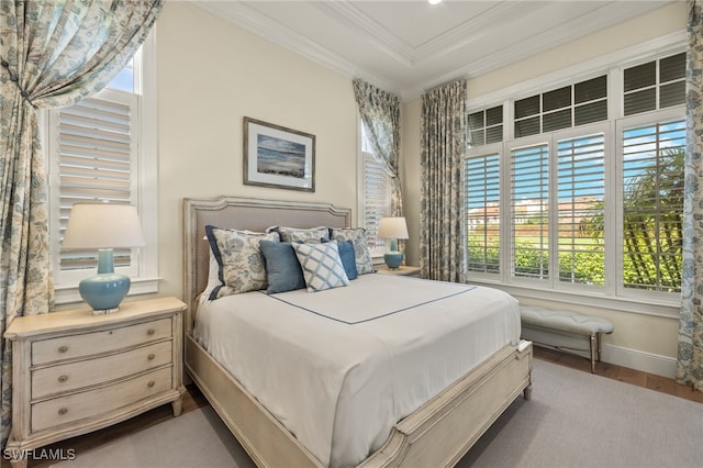 bedroom with hardwood / wood-style floors and ornamental molding