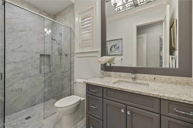 bathroom featuring a shower with shower door, toilet, ornamental molding, and vanity