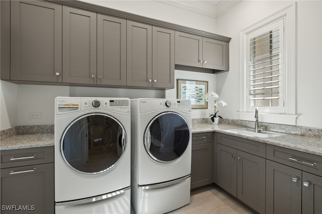 washroom with sink, cabinets, washing machine and dryer, crown molding, and light tile patterned flooring