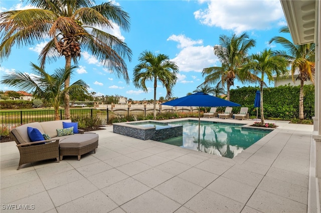 view of pool with a patio area and an in ground hot tub