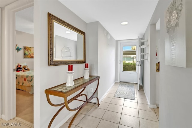 doorway to outside with light tile patterned floors