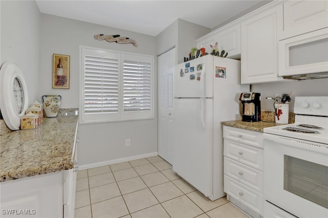 kitchen featuring light stone countertops, light tile patterned floors, white appliances, and white cabinetry