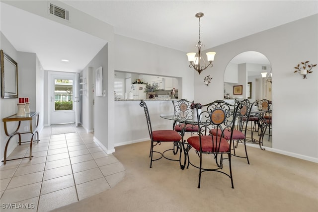 dining space featuring a chandelier and light tile patterned flooring