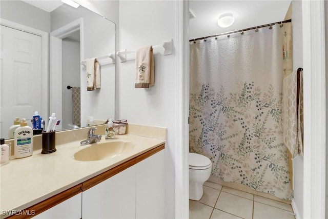 bathroom featuring tile patterned flooring, vanity, and toilet