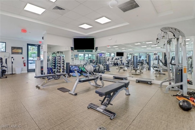 workout area with a drop ceiling and ornamental molding