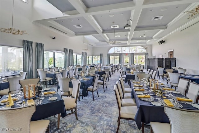 dining room with beam ceiling, plenty of natural light, coffered ceiling, and a high ceiling