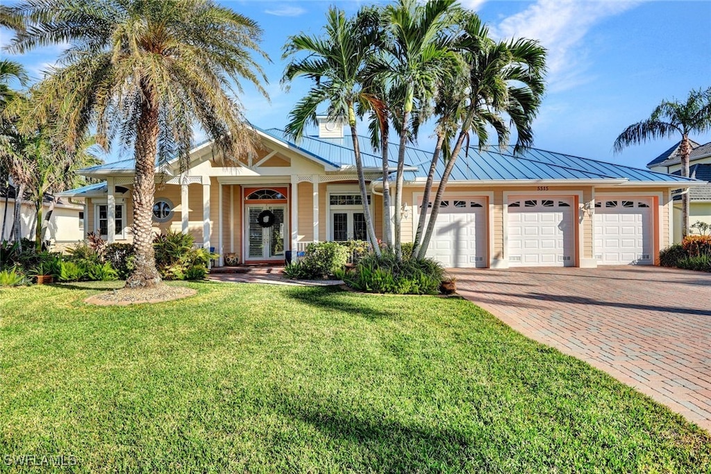 view of front of property with a front lawn and a garage