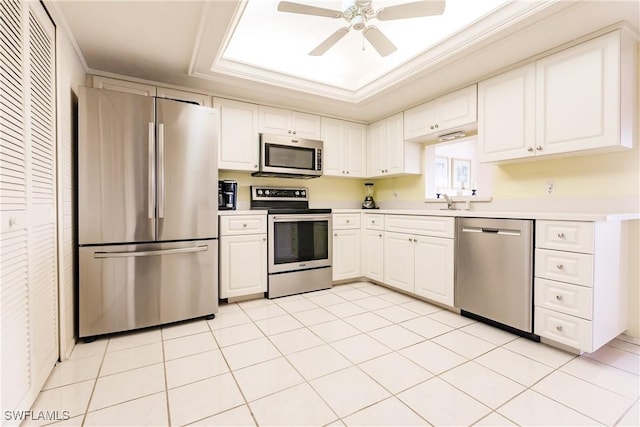 kitchen featuring white cabinetry, ceiling fan, stainless steel appliances, and ornamental molding