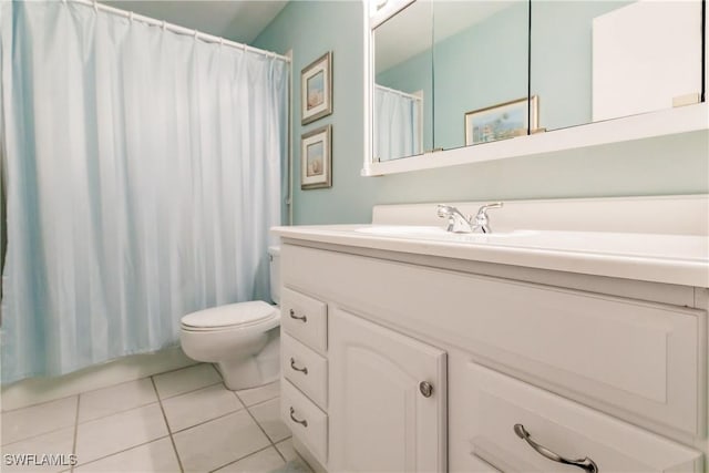 bathroom with a shower with curtain, tile patterned flooring, vanity, and toilet