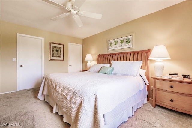 bedroom featuring ceiling fan and light carpet