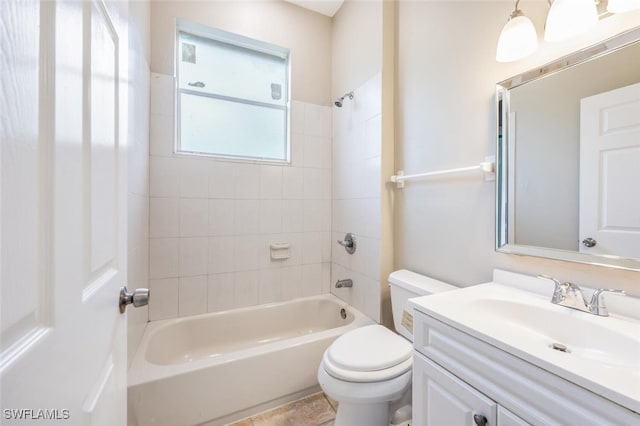 full bathroom with vanity, tiled shower / bath combo, and toilet