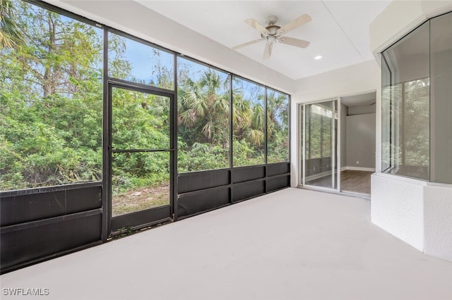 unfurnished sunroom with ceiling fan and a healthy amount of sunlight