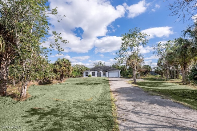 view of front facade featuring a front yard and a garage