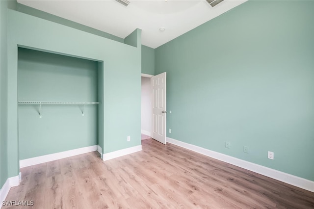 unfurnished bedroom featuring a closet and light hardwood / wood-style flooring