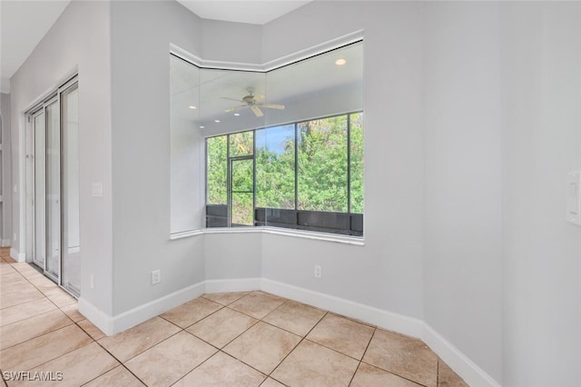 unfurnished room with ceiling fan and light tile patterned flooring