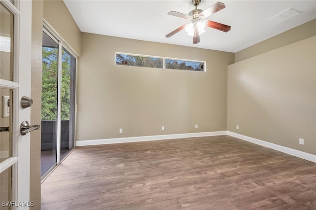 empty room with hardwood / wood-style floors and ceiling fan