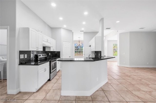 kitchen featuring kitchen peninsula, backsplash, light tile patterned floors, white cabinets, and stainless steel electric range