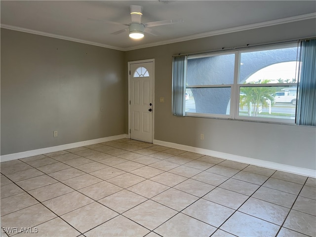 tiled entryway featuring ceiling fan and crown molding