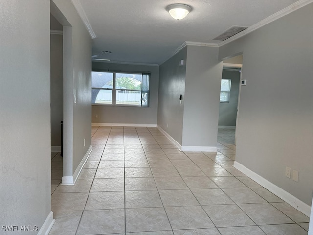 corridor featuring light tile patterned flooring and ornamental molding