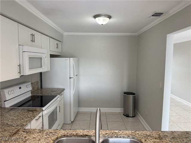 kitchen with dark stone counters, ornamental molding, white appliances, sink, and white cabinets