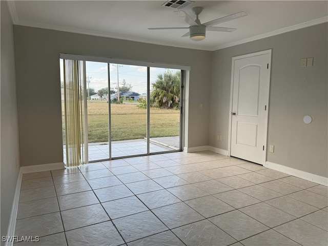 tiled spare room featuring ceiling fan and crown molding